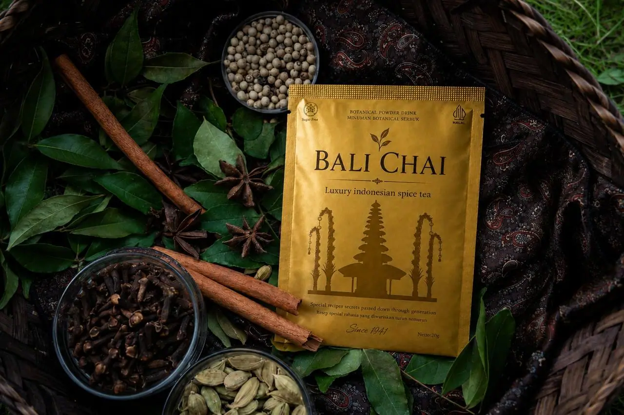 Bali Chai pouch in a basket surrounded by whole Indonesian spices and pepper